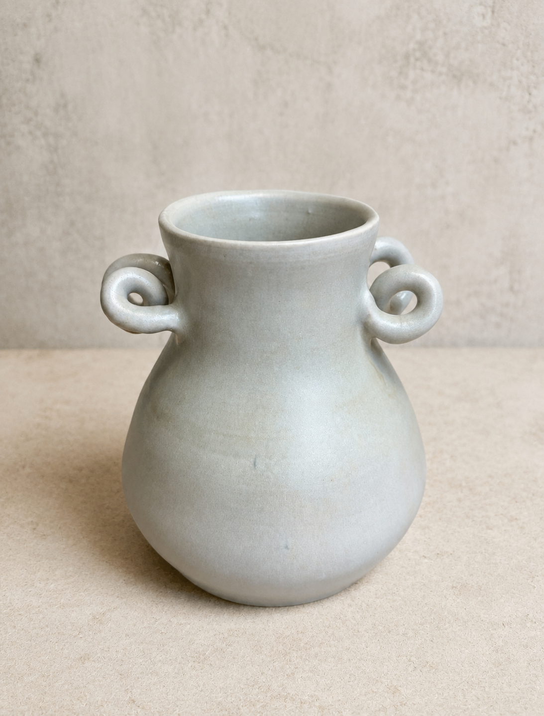 Pale grey vase with sculpted curled handles